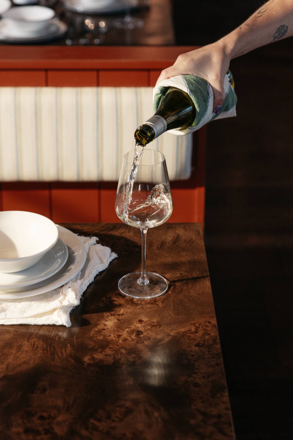 White wine being poured into a Made In Crystal White Wine Glass
