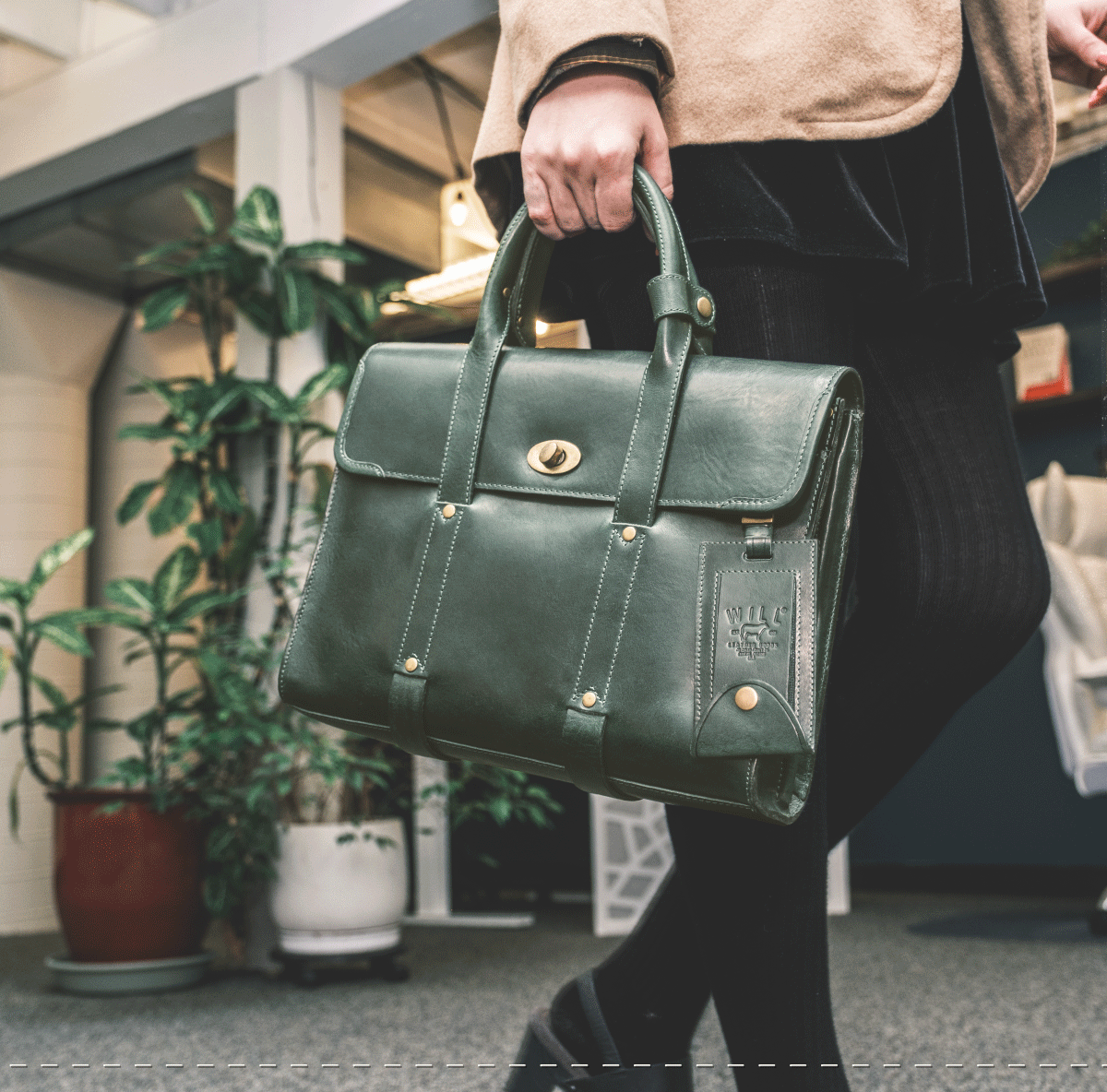Green William Collection bag carried by hand