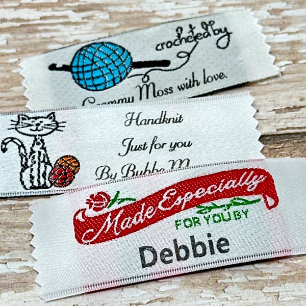 Assortment of custom woven name labels, including handknit and Made Especially For You tags