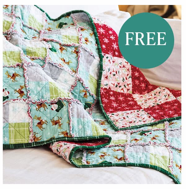 FREE. A handmade Christmas themed quilt draped over a couch