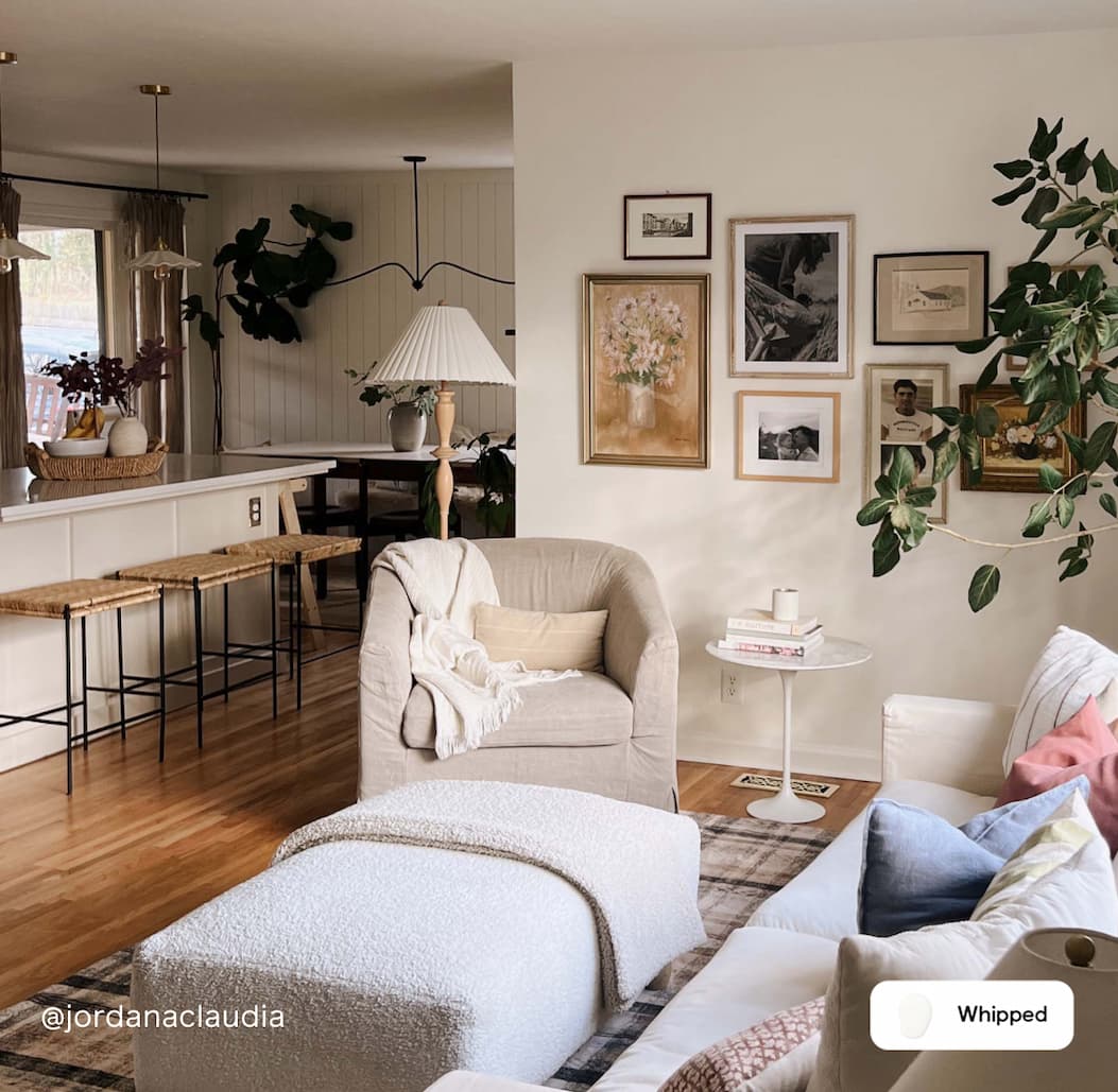 Open concept living space featuring the living room, kitchen and dining area. All walls are painted in best-selling creamy white paint color Whipped.