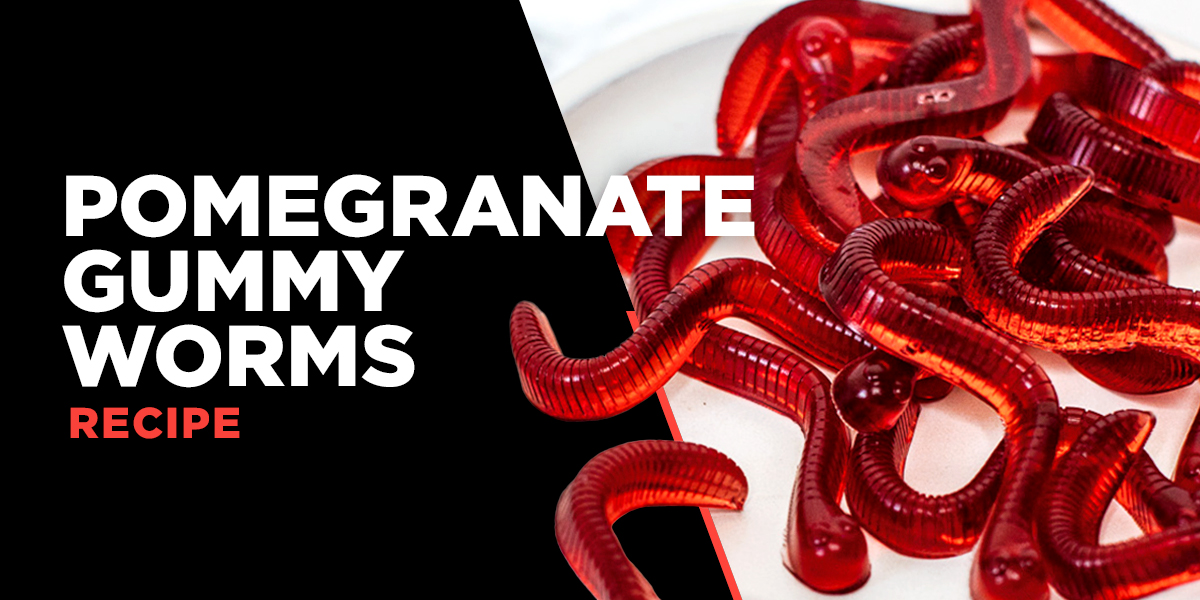 Recipe header for "Pomegranate Gummy Worms" showing a pile of translucent red gummy worms on a white plate.