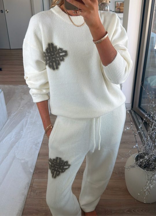 Community member in a cream Emblem Fluffy Knit jumper and joggers