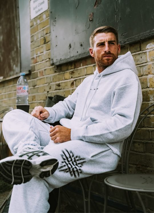 Community member in a grey marl tracksuit