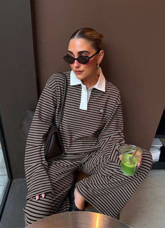 Community member in a brown striped polo co-ord
