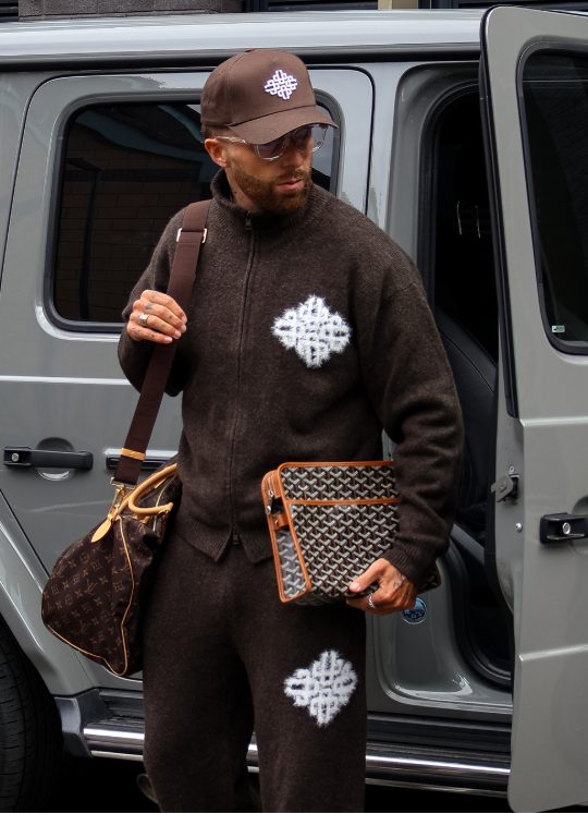 Community member in the brown Emblem Fluffy Knit funnel neck and joggers