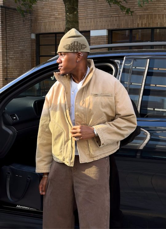 Community member in a stone canvas jacket and beanie
