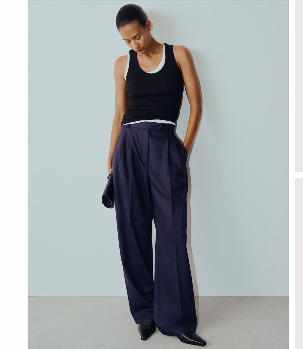 Midnight trousers and a classic ribbed tank make an effortless pairing that balances tailored structure with everyday ease.