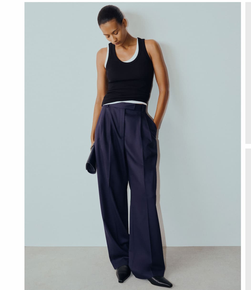 Midnight trousers and a classic ribbed tank make an effortless pairing that balances tailored structure with everyday ease. Midnight trousers and a classic ribbed tank make an effortless pairing that balances tailored structure with everyday ease.