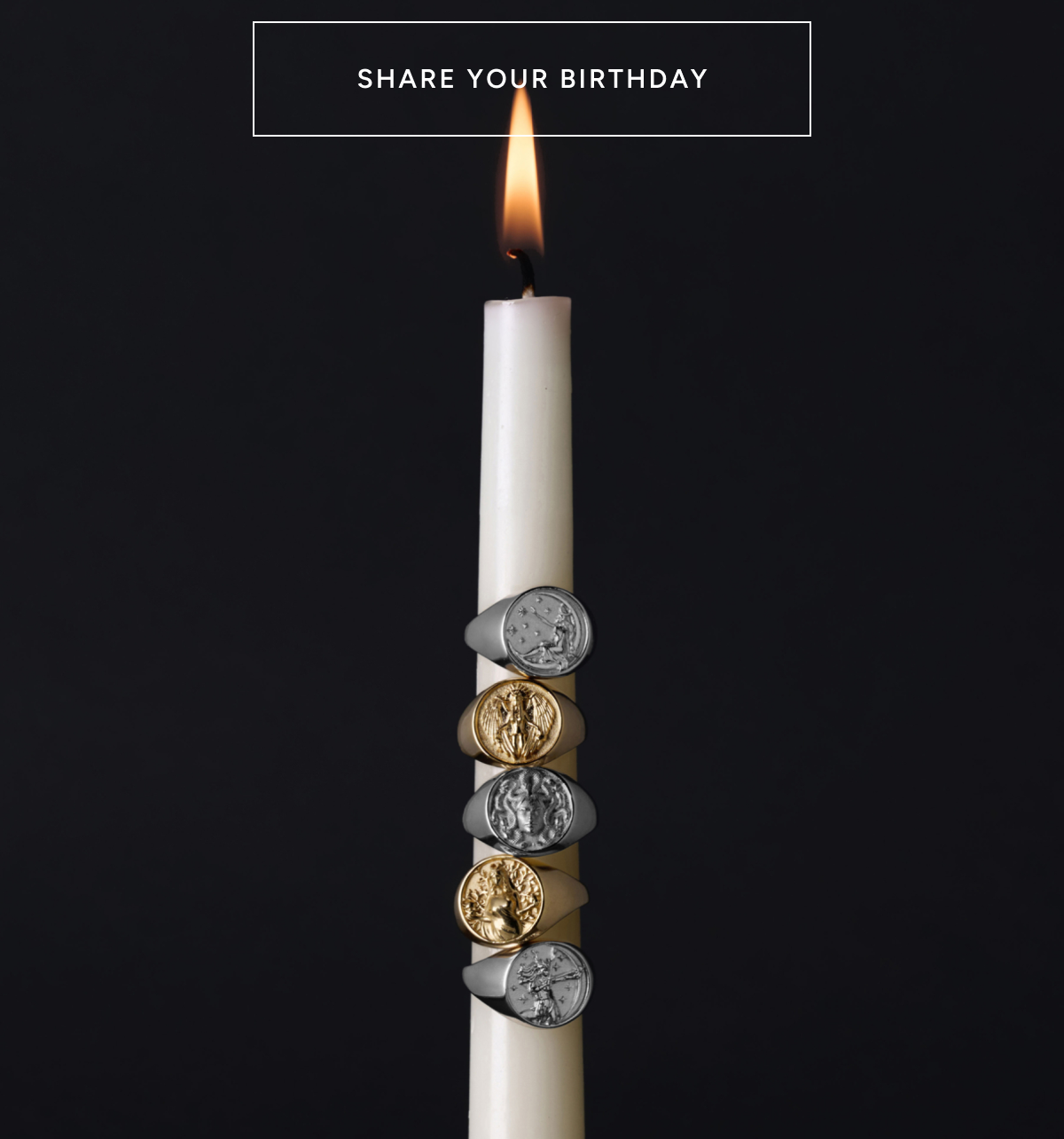 Share your birthday. A lit candle stacked with Awe Goddess signet rings.