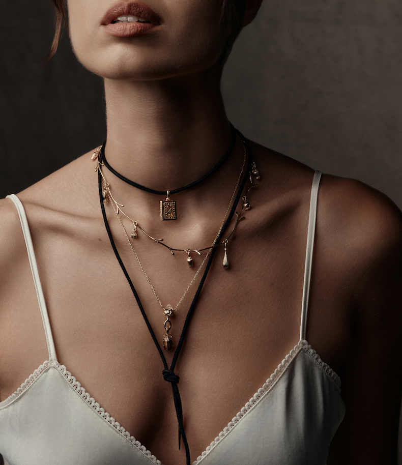 Model wearing layered Awe x Practical Magic 2 necklaces