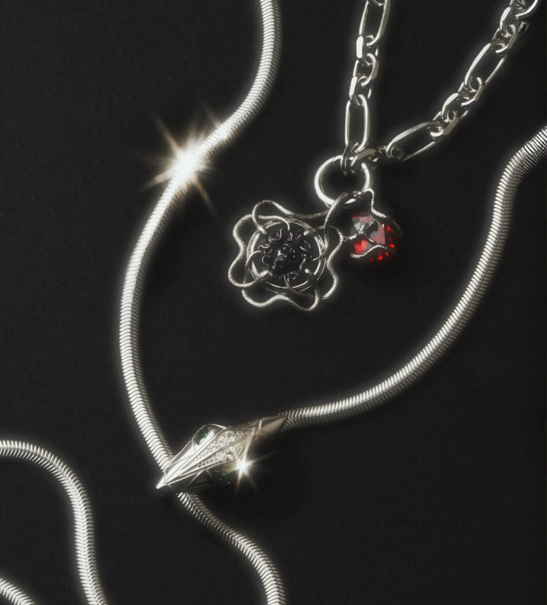 Silver snake chains with the Medusa cameo pendant and charms on black