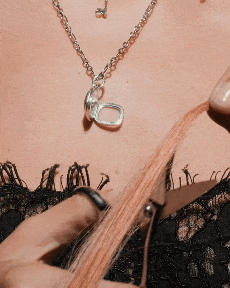 Model wearing the open Twin Serpent Mourning Locket