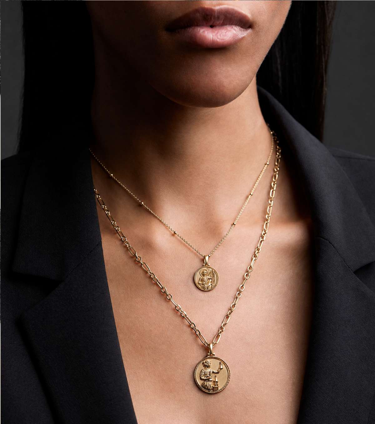 Woman wearing two Real-Life Goddess pendants