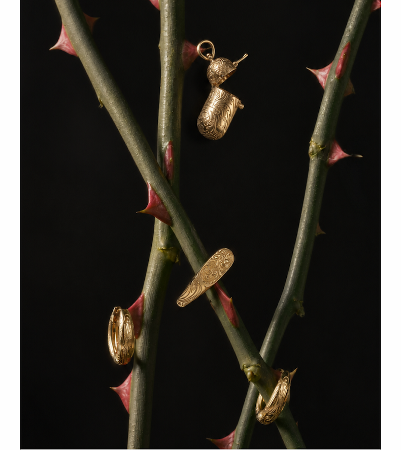 Engraved pillbox pendant, signet ring and hoops among thorned branches