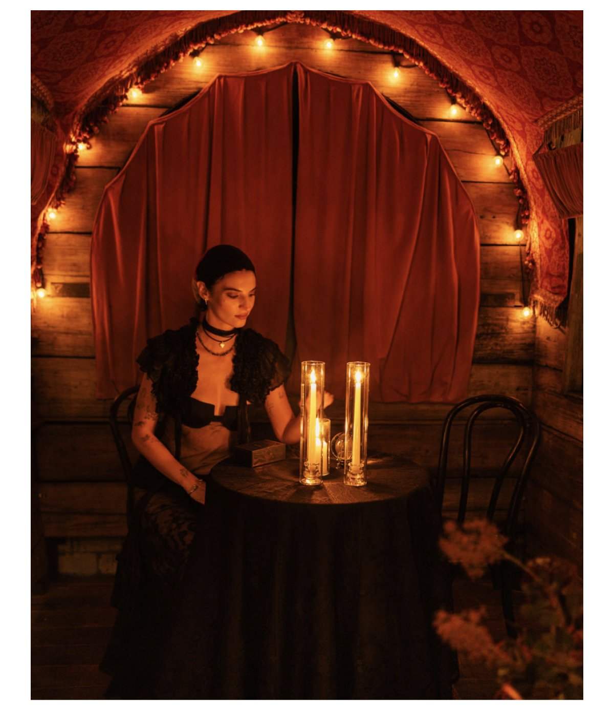 Guest at a candlelit tarot reading table