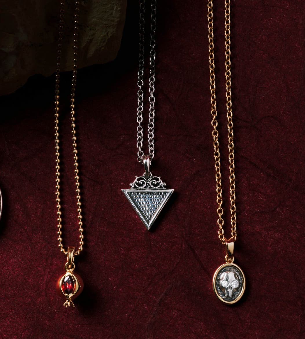 Abracadabra Filigree Pendant and Nocturne pendants on red velvet