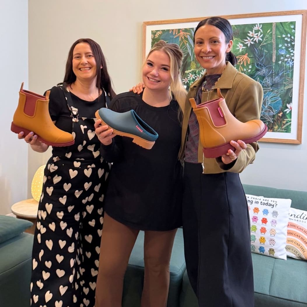 Dani & Bridge It team holding boots