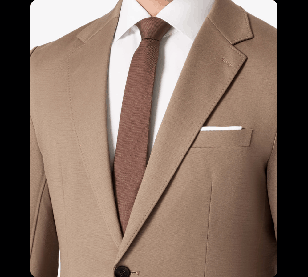 Mid-Brown Sharp Without the Formality Mid-Brown sits in a different register than black or navy. Lighter without being casual. The client dinner that calls for a suit but not a dark one. The weekend event where you want to look sharp without looking like you're heading to a boardroom. Brown shoes. White shirt. Cognac belt. It finishes itself. Mid-Brown is the one to add next. Same machine-washable construction. Same 4-Way Stretch. SHOP MID-BROWN