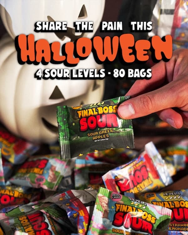 Holiday Minis single-serve Halloween packs fanned out in a candy bowl, four fruits across four sour levels, with faint Christmas accents on the packaging