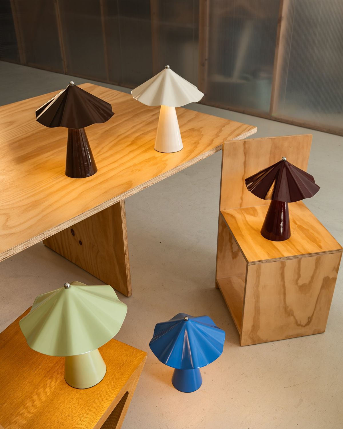 Robyn lamps in all five colours on plywood tables and stools
