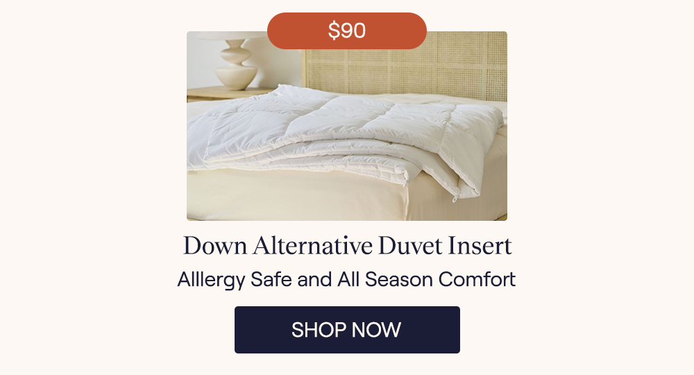 A Down Alternative Duvet Insert laying on the edge of a bed