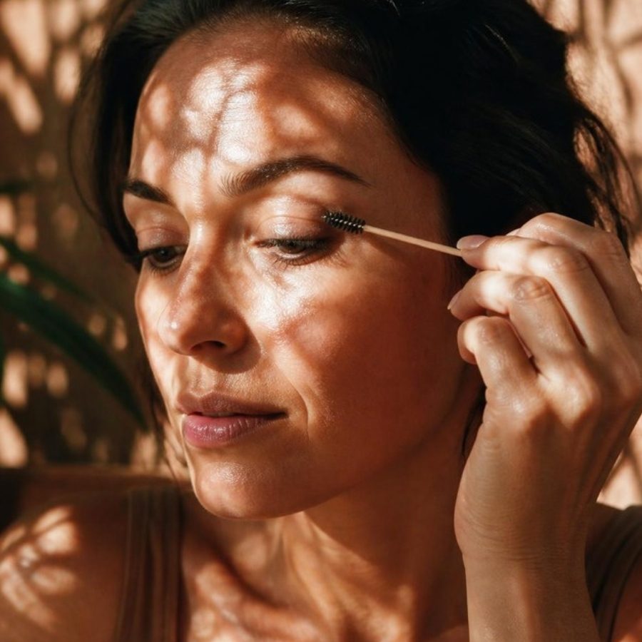 Applying castor oil to the lashes with a spoolie