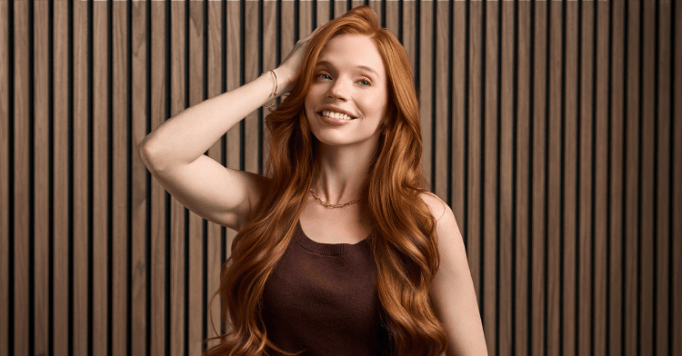 Woman with red hair in brown shirt.
