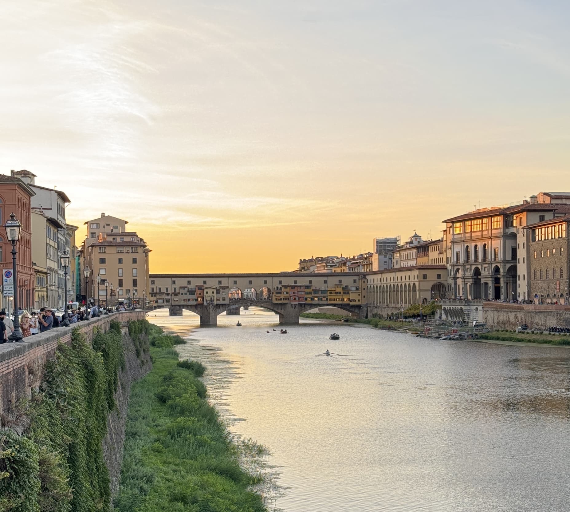 The Ponte Vecchio spans the Arno River at sunset, surrounded by the historic buildings of Florence, Italy. Fearrington Village.
