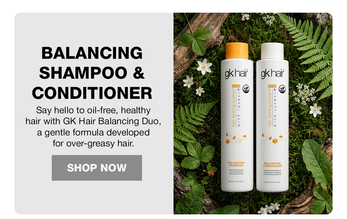 GK Hair Balancing Shampoo and Conditioner bottles among ferns and white flowers, with Shop Now button