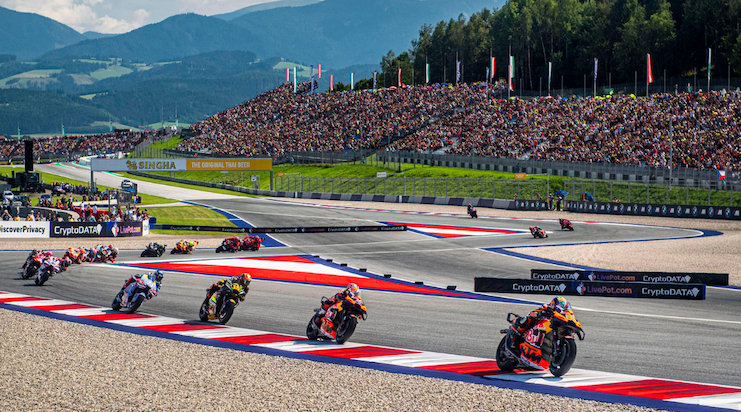 MotoGP riders leaning into a corner