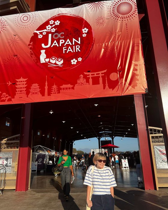 Miki at the OC Japan Fair entrance gate in 2024, the year we visited as customers
