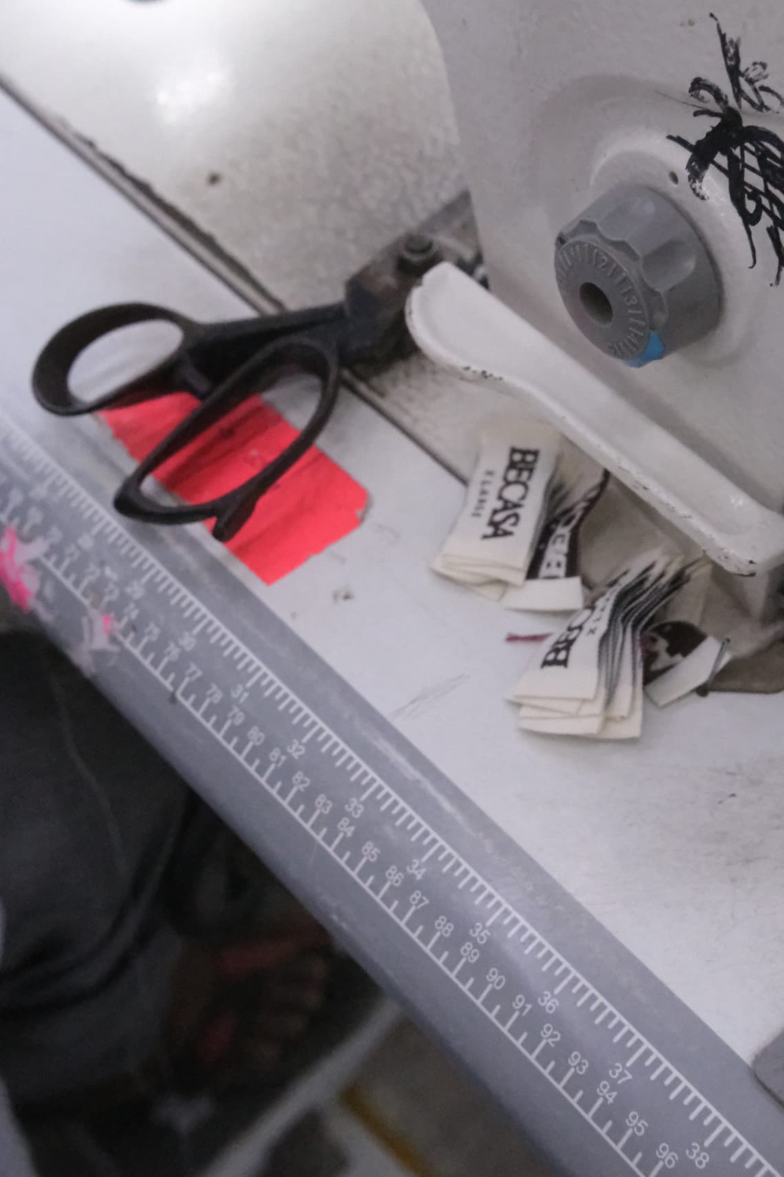 BECASA labels and scissors beside a sewing machine