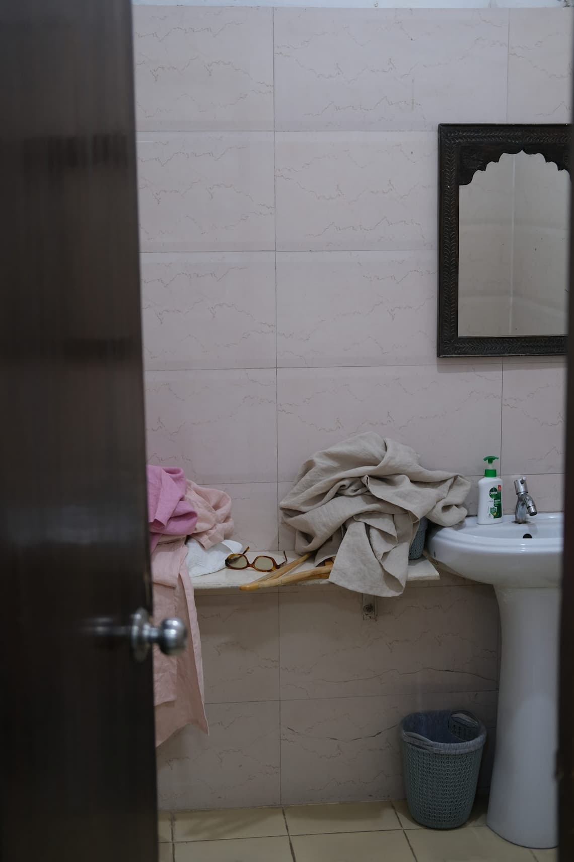 Fabric samples draped by the sink in our hotel bathroom