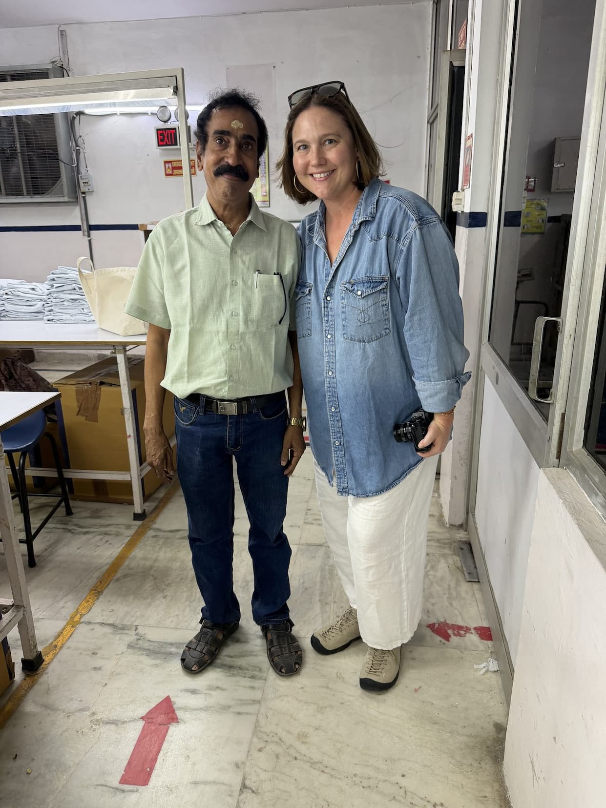 Emily standing with a colleague on the factory floor