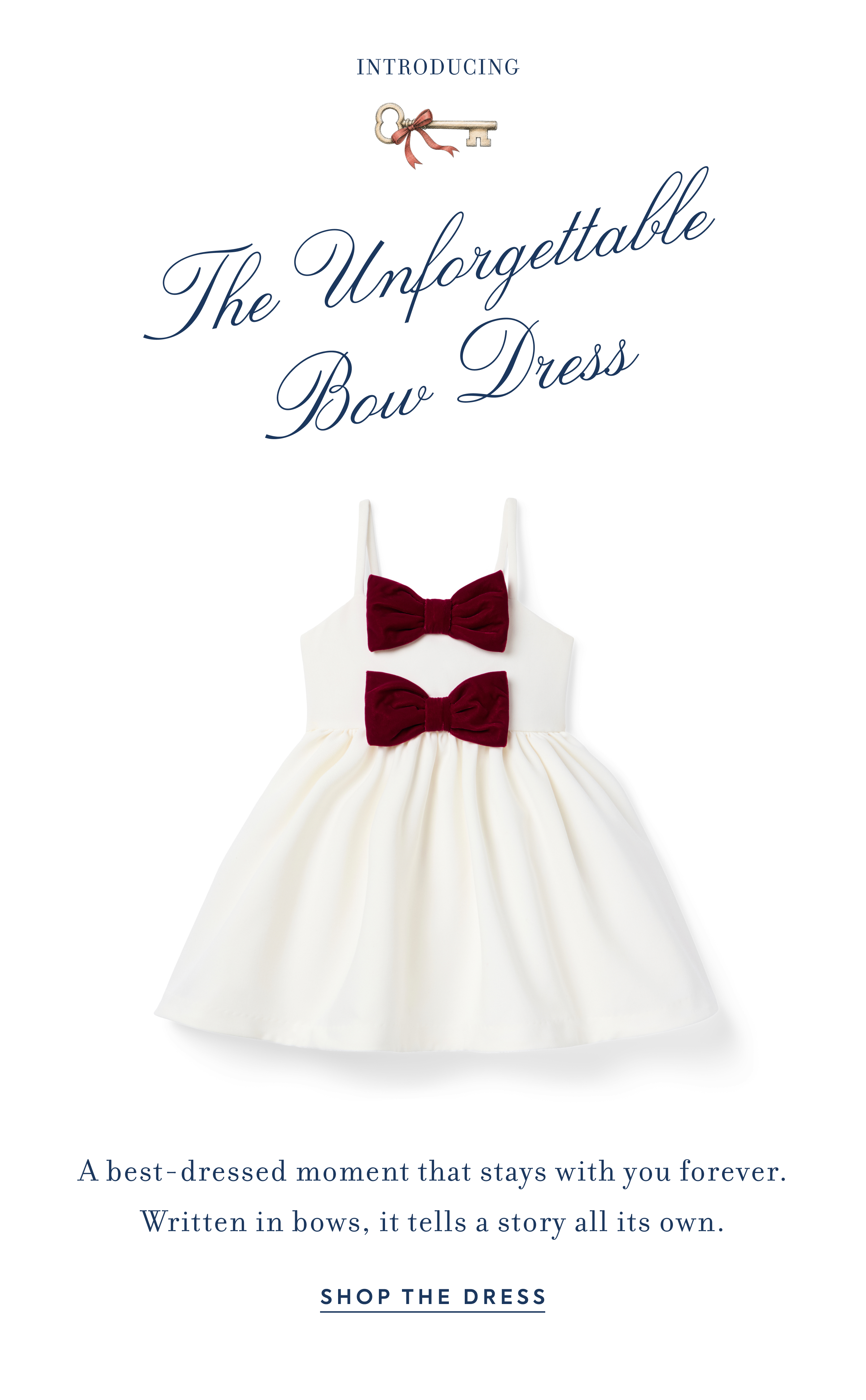 White children's dress with two dark red velvet bows - Introducing The Unforgettable Bow Dress - A best-dressed moment that stays with you forever. Written in bows, it tells a story all its own. - SHOP THE DRESS