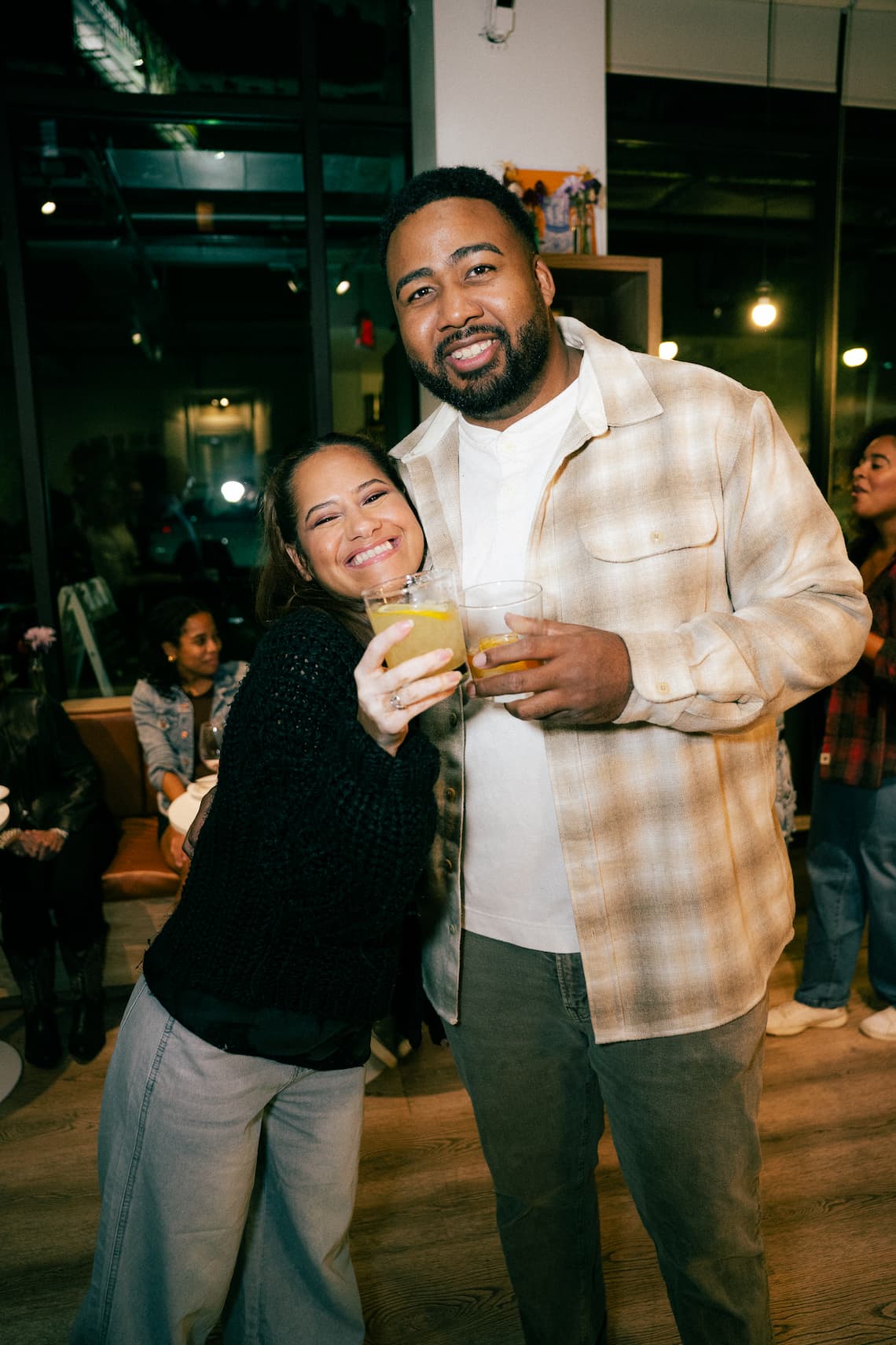 Two guests raising their drinks