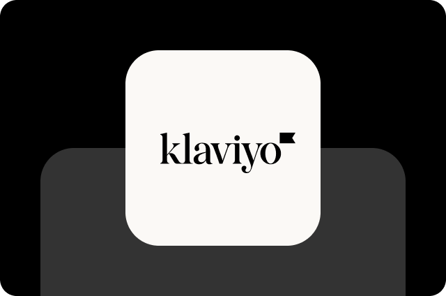 Dark charcoal background with a medium gray offset shadow, featuring an off-white rounded square icon with the Klaviyo logo in black serif lettering with a small black flag mark.