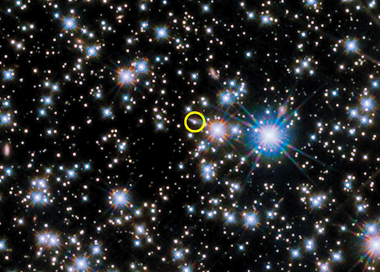 Star-filled image showing the dwarf planet candidate circled in yellow among numerous bright stars.