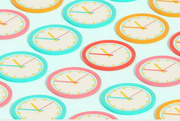 An array of colorful wall clocks viewed at a diagonal angle.