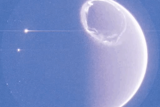 GIF of a storm of ultraviolet light swirling over a planet.