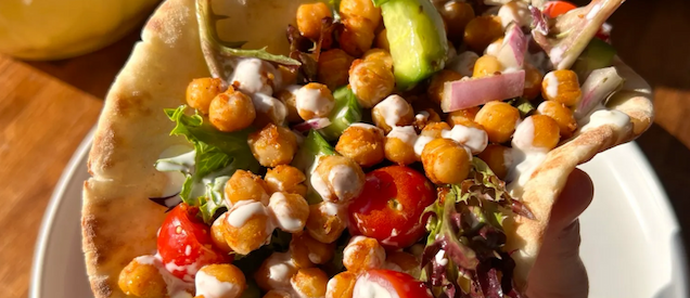 A Palestinian pantry spread with olive oil, bread, and vegetables