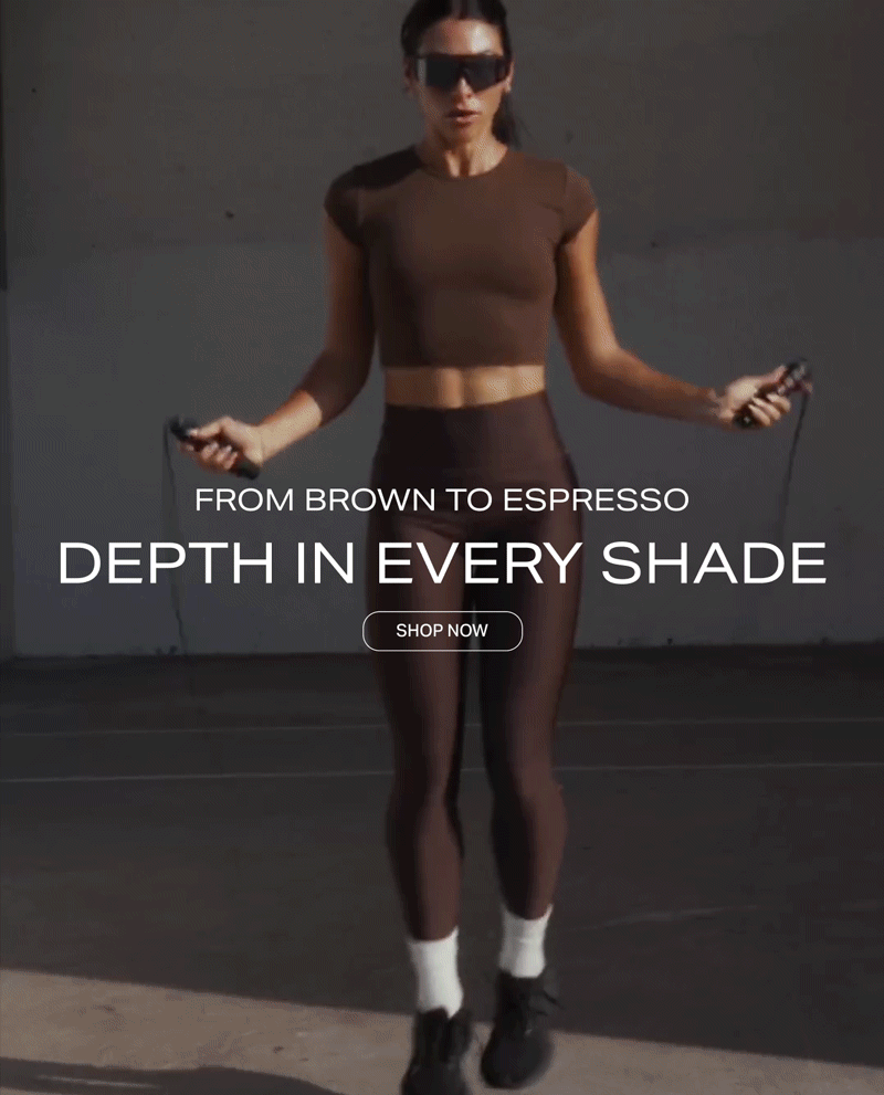 Athletic woman jumping rope wearing dark espresso brown activewear set, promoting a new workout apparel collection with a Shop Now button.
