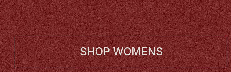 White framed text reading "SHOP WOMENS" on a dark red textured background, serving as a call-to-action button for women's apparel.