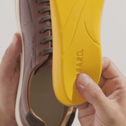 Brown leather Presidio sneakers with white soles and a "Hubbard Rebound System" label.