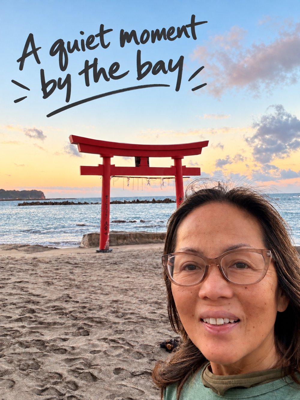 Rina beside the bay with a red torii gate